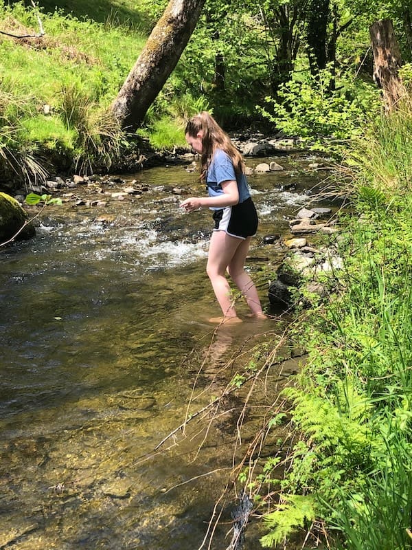 Child paddling safely in the river