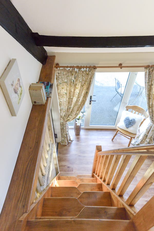 The hit-and-miss staircase viewed from the top, showing the alternating narrow treads and the handrail on one side